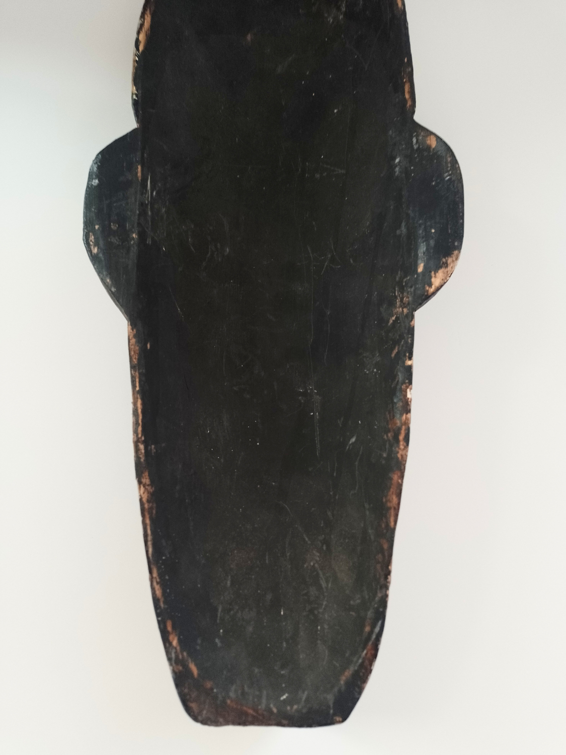 Balinese mask reverse with a worn texture on a white background