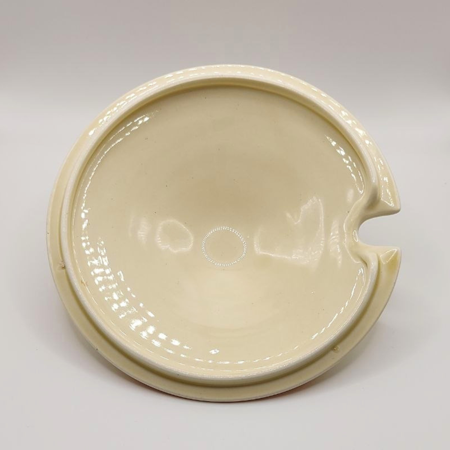Beige ceramic tureen lid on a white background