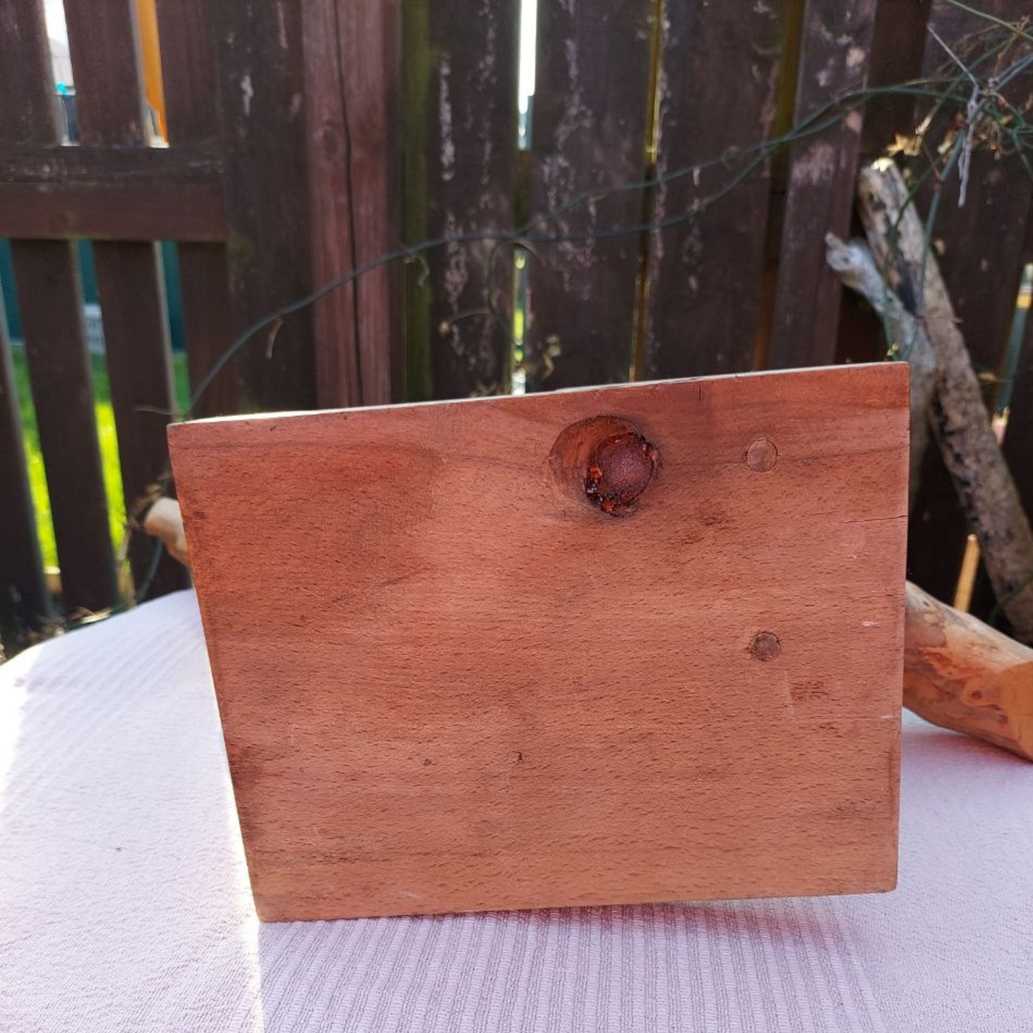 The base of a driftwood sculpture on a garden table.