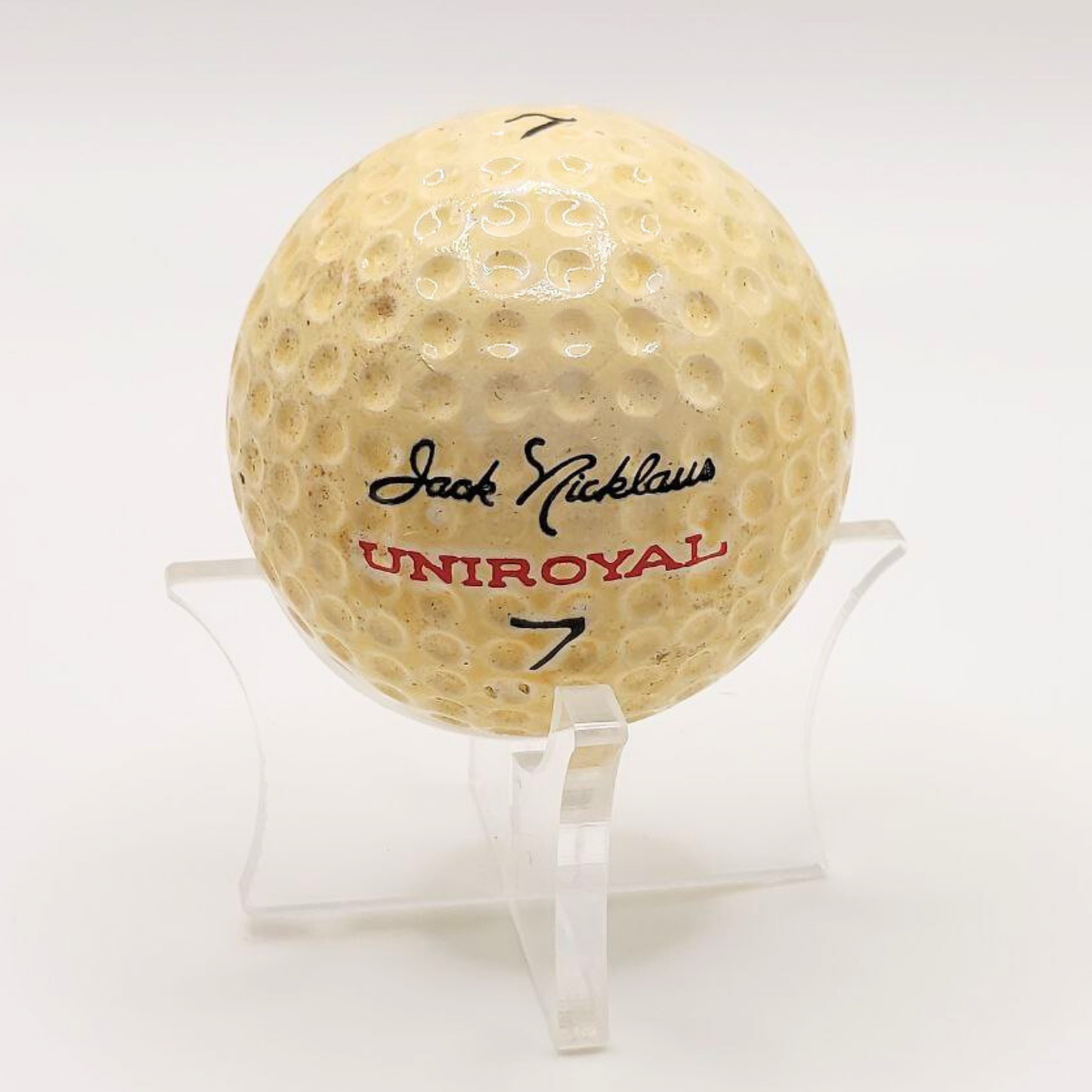 A close up shot of a 1960s/1970s Jack Nicklaus Uniroyal golf ball.