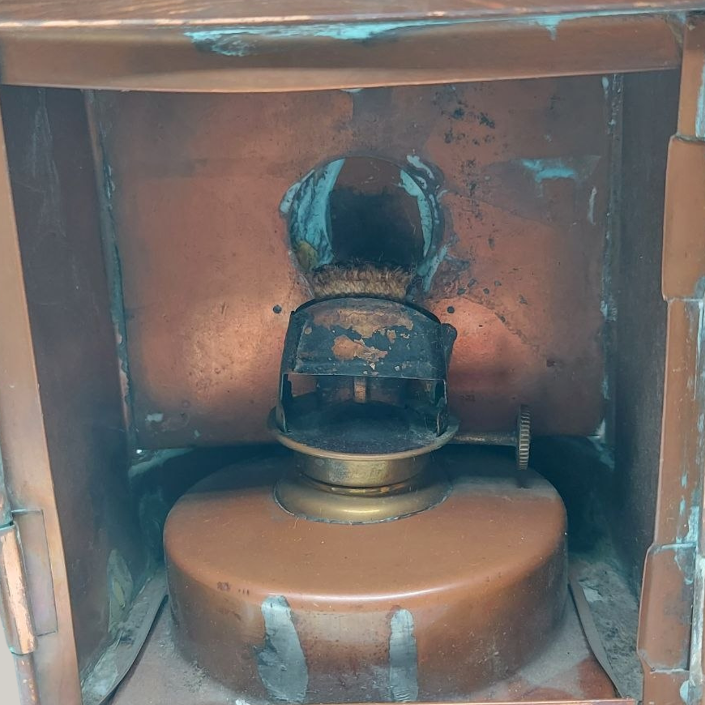 Vintage-style oil lamp with a brown base and copper components.