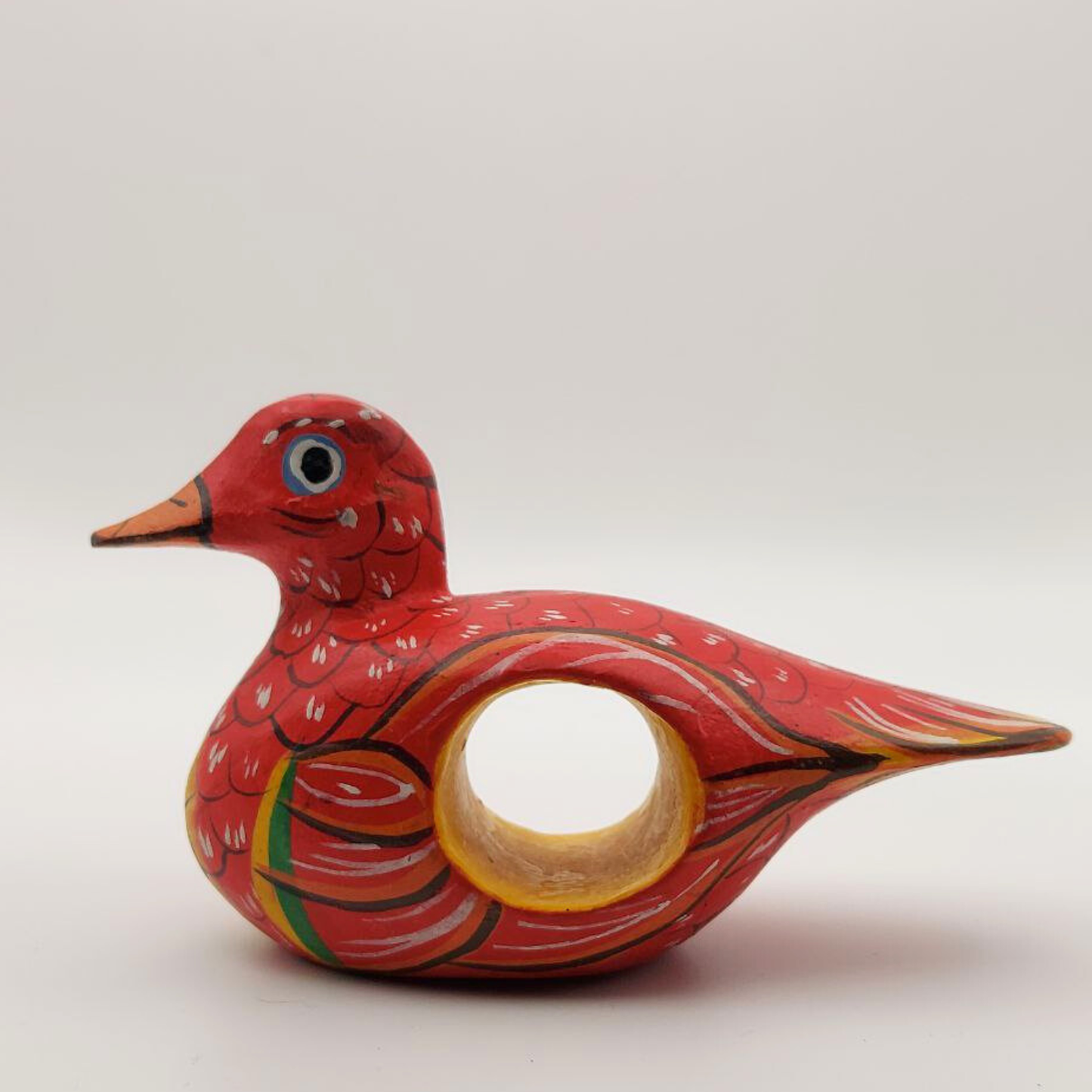 A small red duck napkin holder on a white background