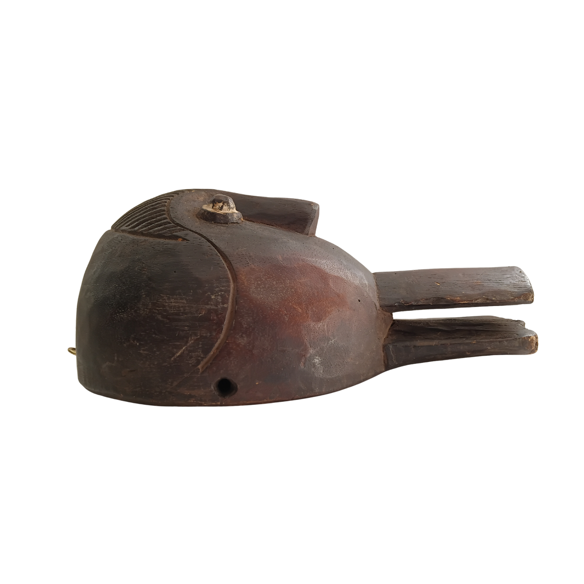 A dark brown carved wooden spoon featuring a small circular eye detail and a small hole near the front, shown against a plain white background.