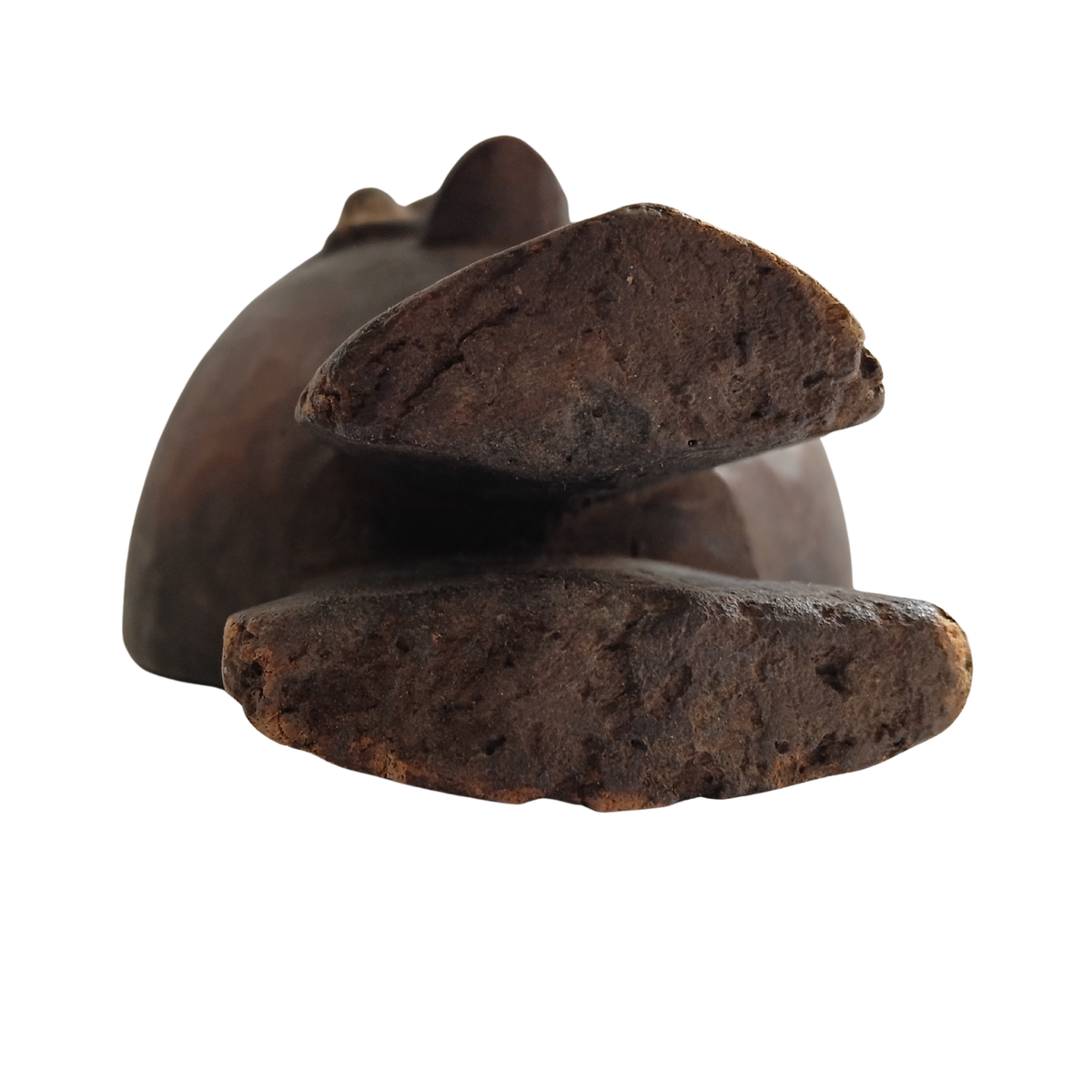A dark brown, textured African spoon, shown from a side profile against a solid white background.