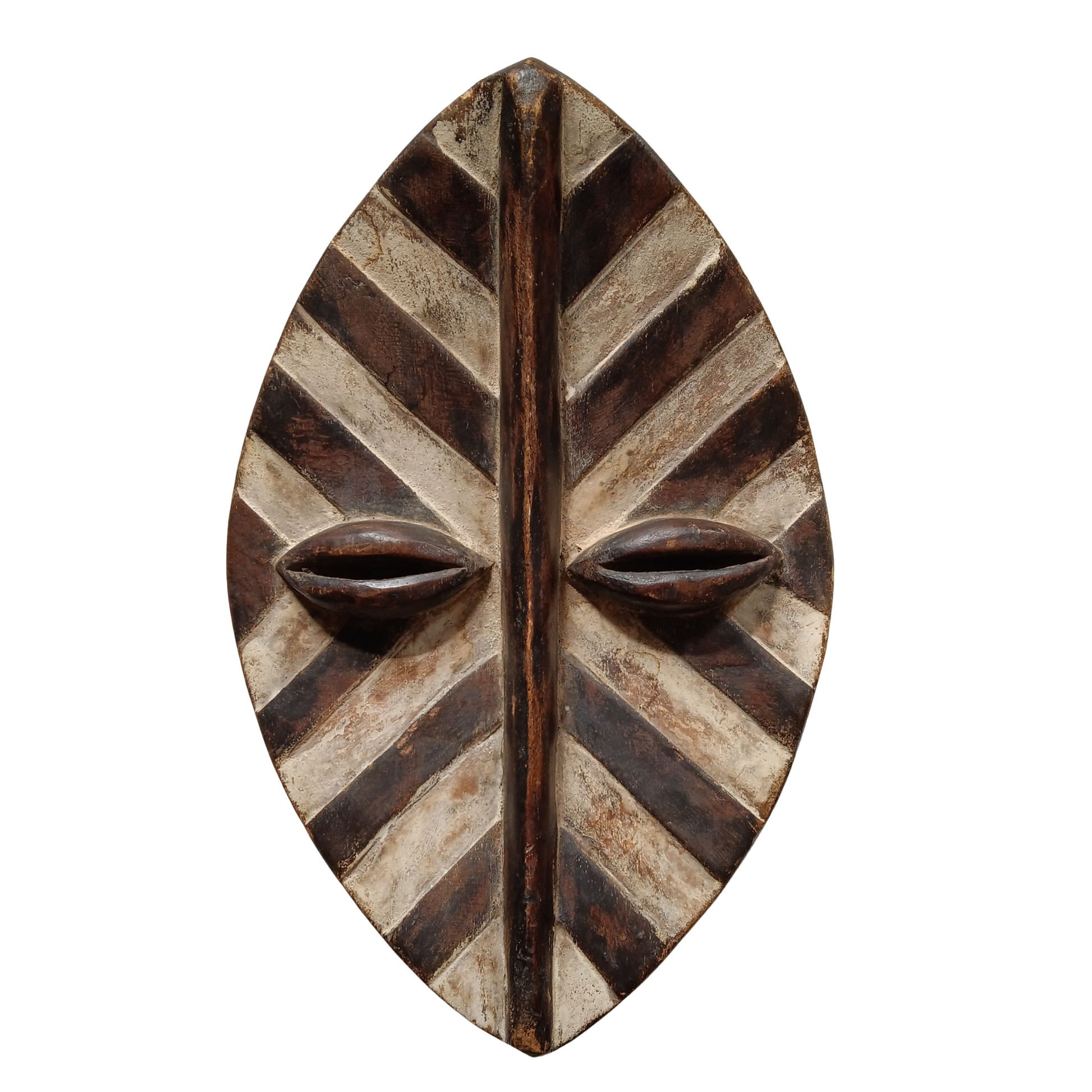 A hand-carved African wooden  mask with a leaf-like shape, featuring diagonal carved stripes and two prominent carved eyes, shown against a plain white background.