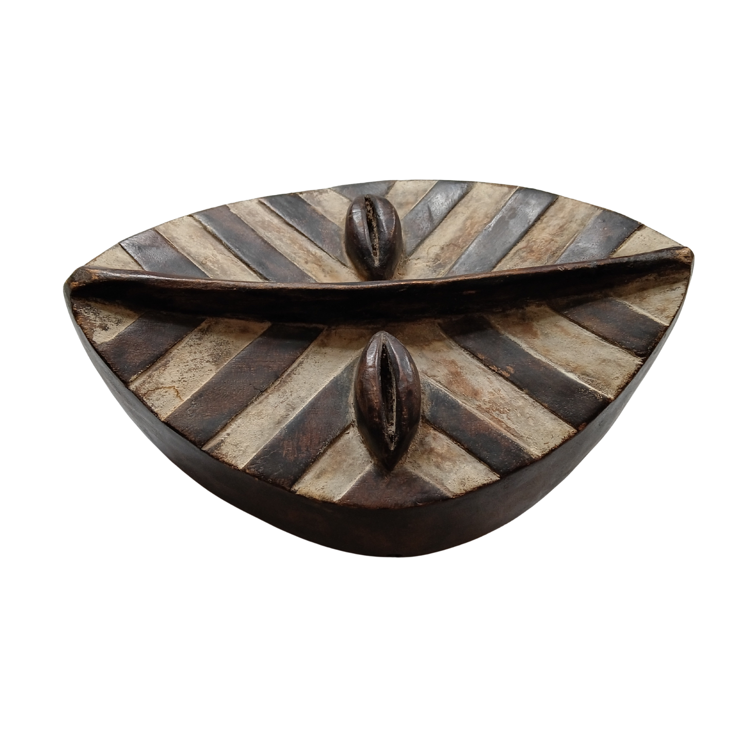 A decorative African wooden mask from the side view against a white background. 