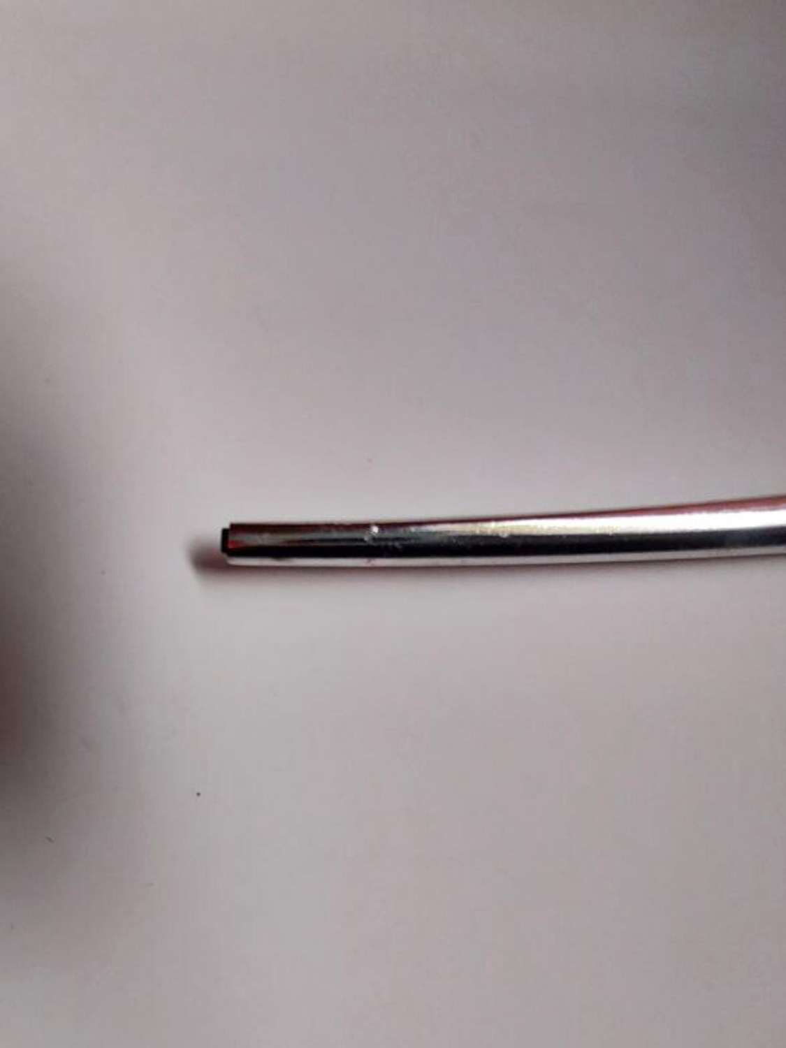 Metal leg on a light grey background