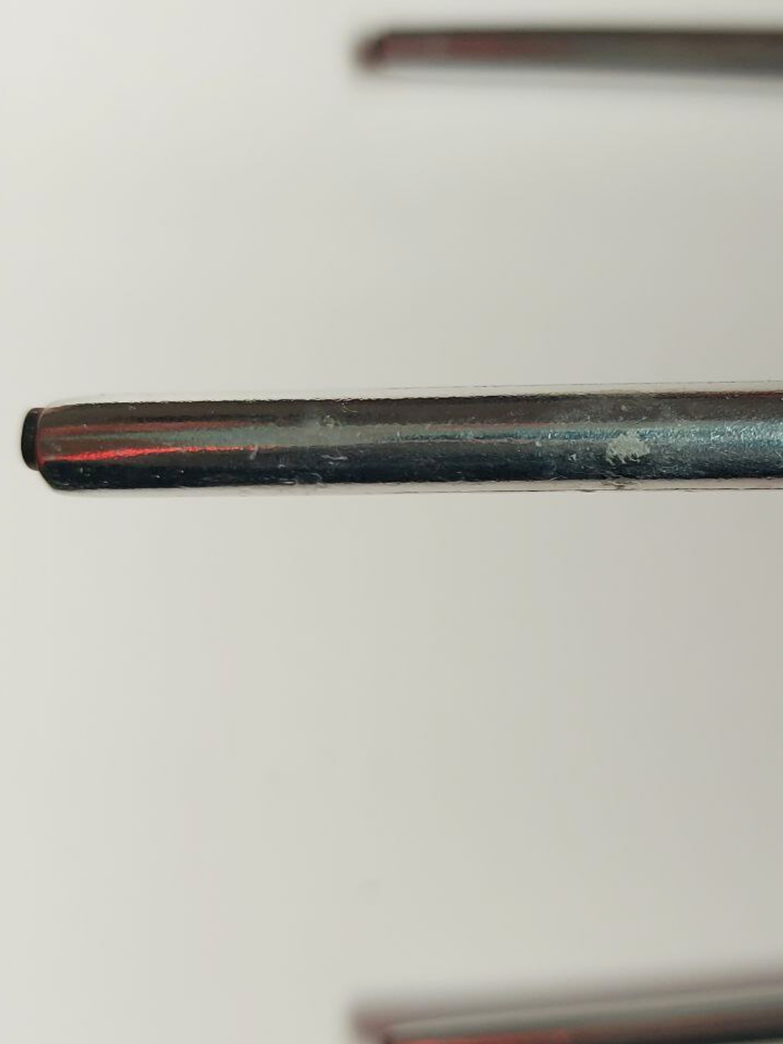 Close-up of a black cylindrical object on a white background