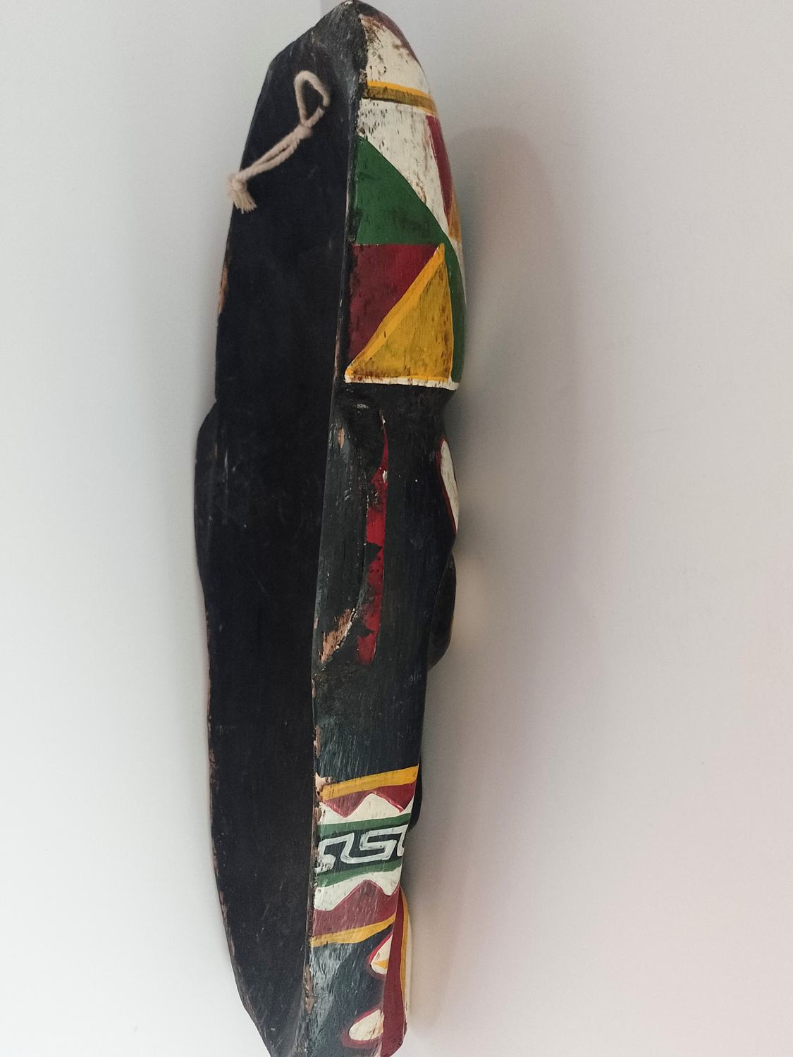 Decorative mask with colourful patterns on a white background