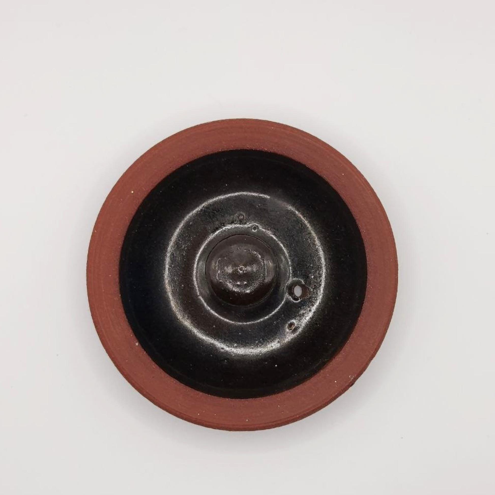 Ceramic teapot lid on a white background