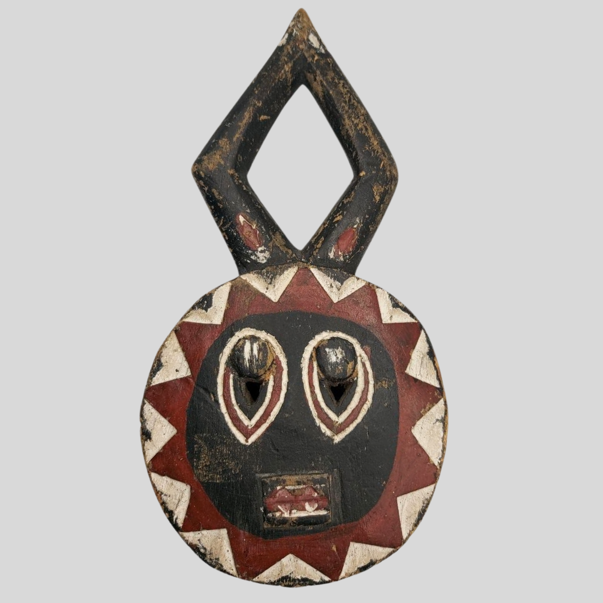 Decorative mask with geometric patterns on a grey background