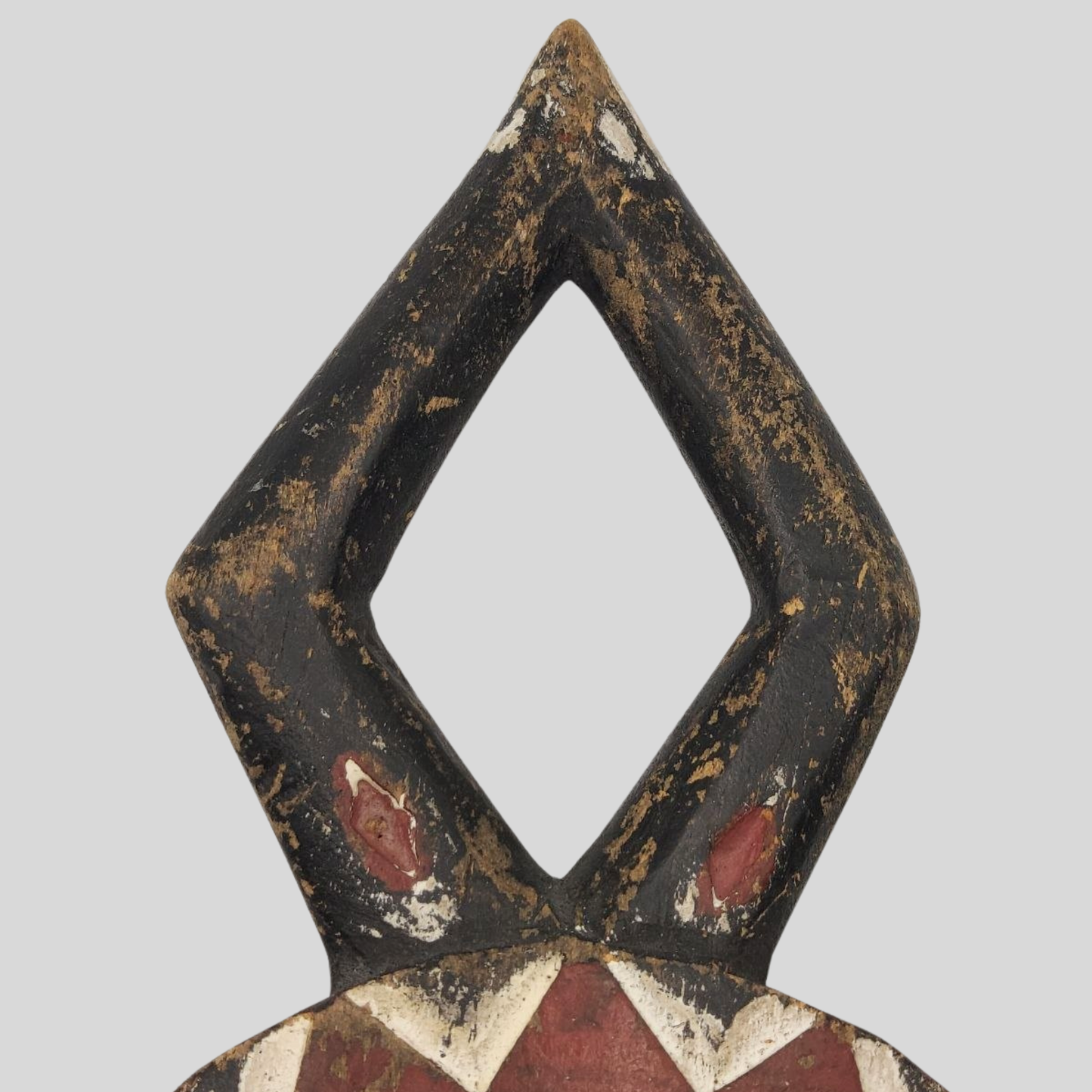 Decorative African mask with geometric design on a grey background