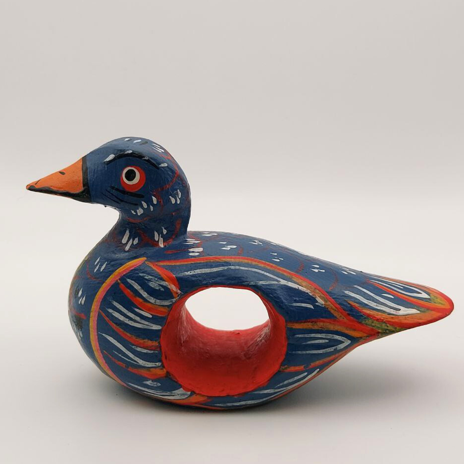 A blue duck napkin holder on a white background