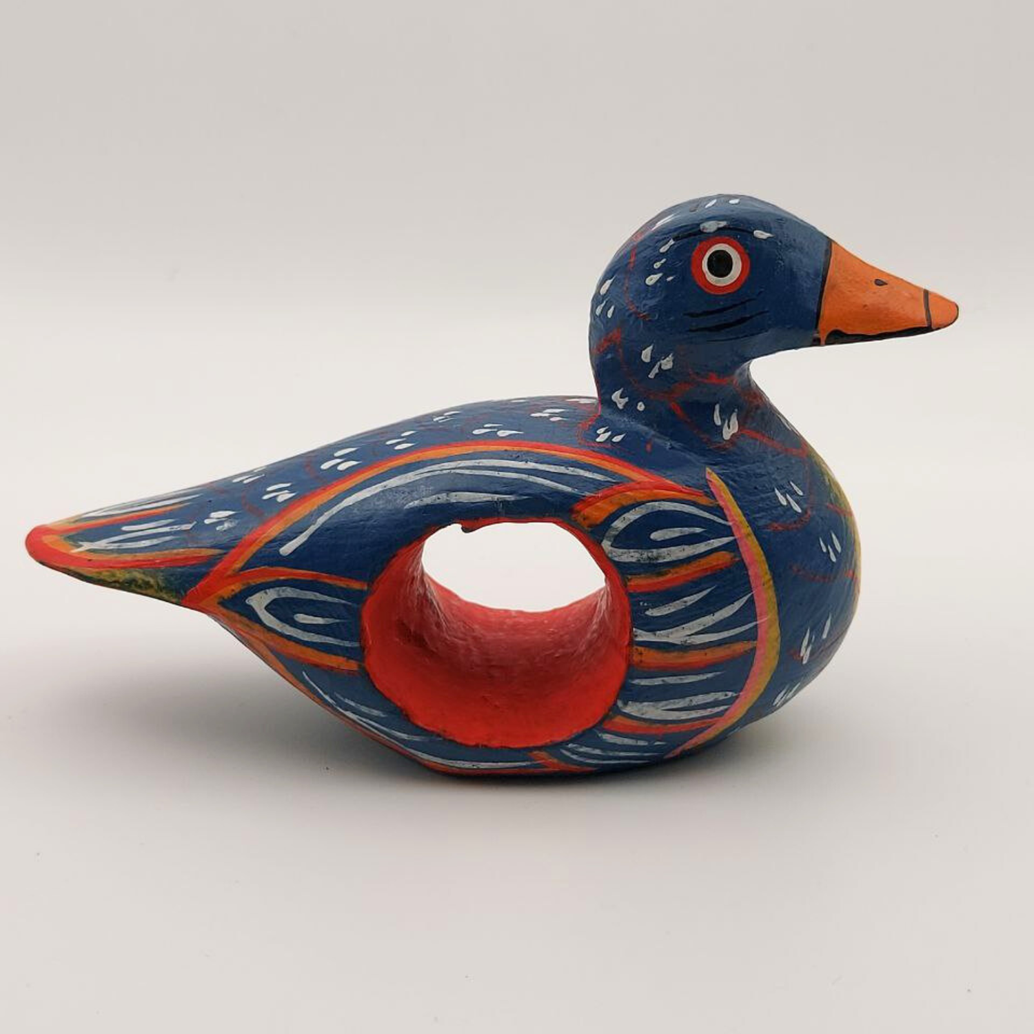 A small blue duck napkin holder on a white background
