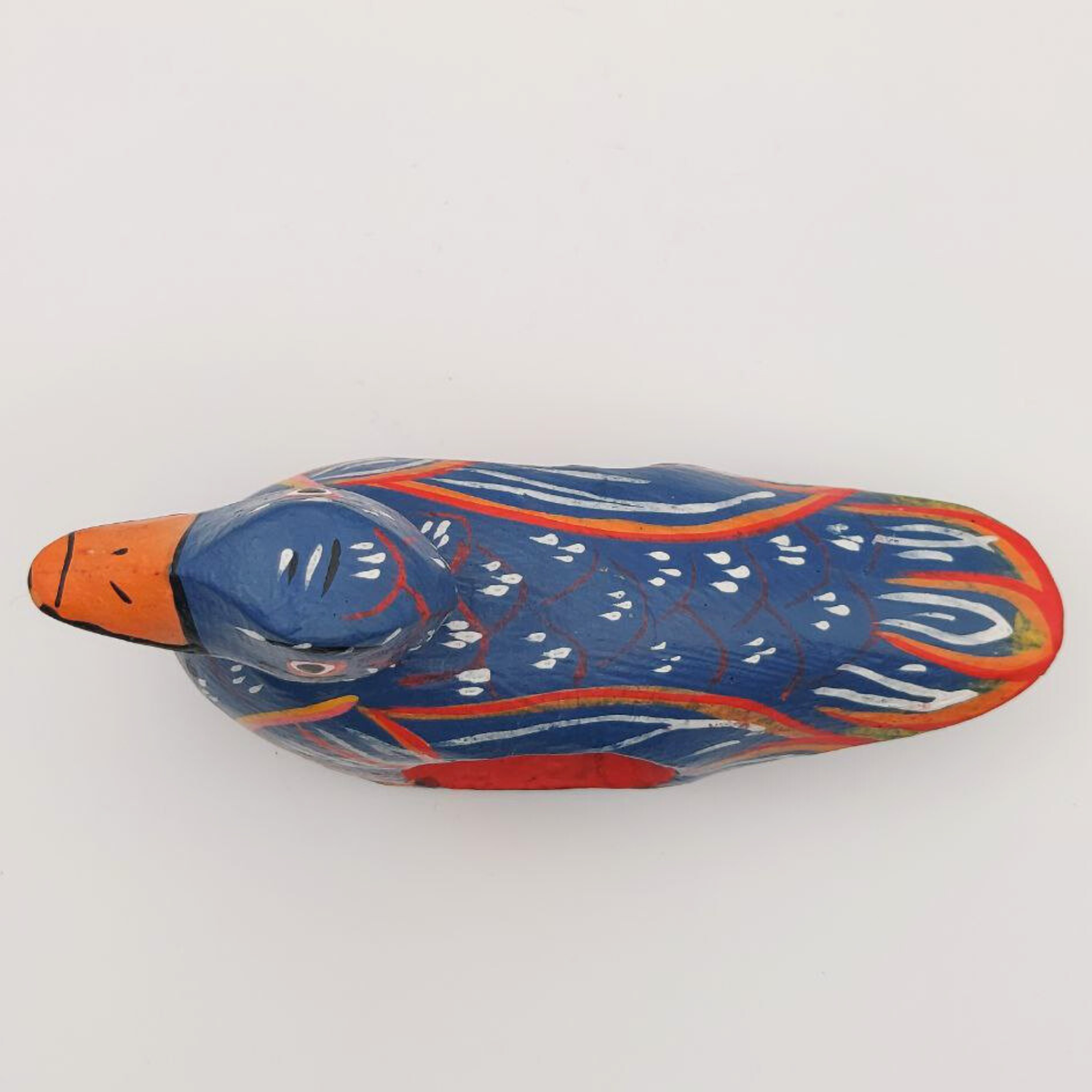 A top-down view of a blue duck napkin holder on a white background