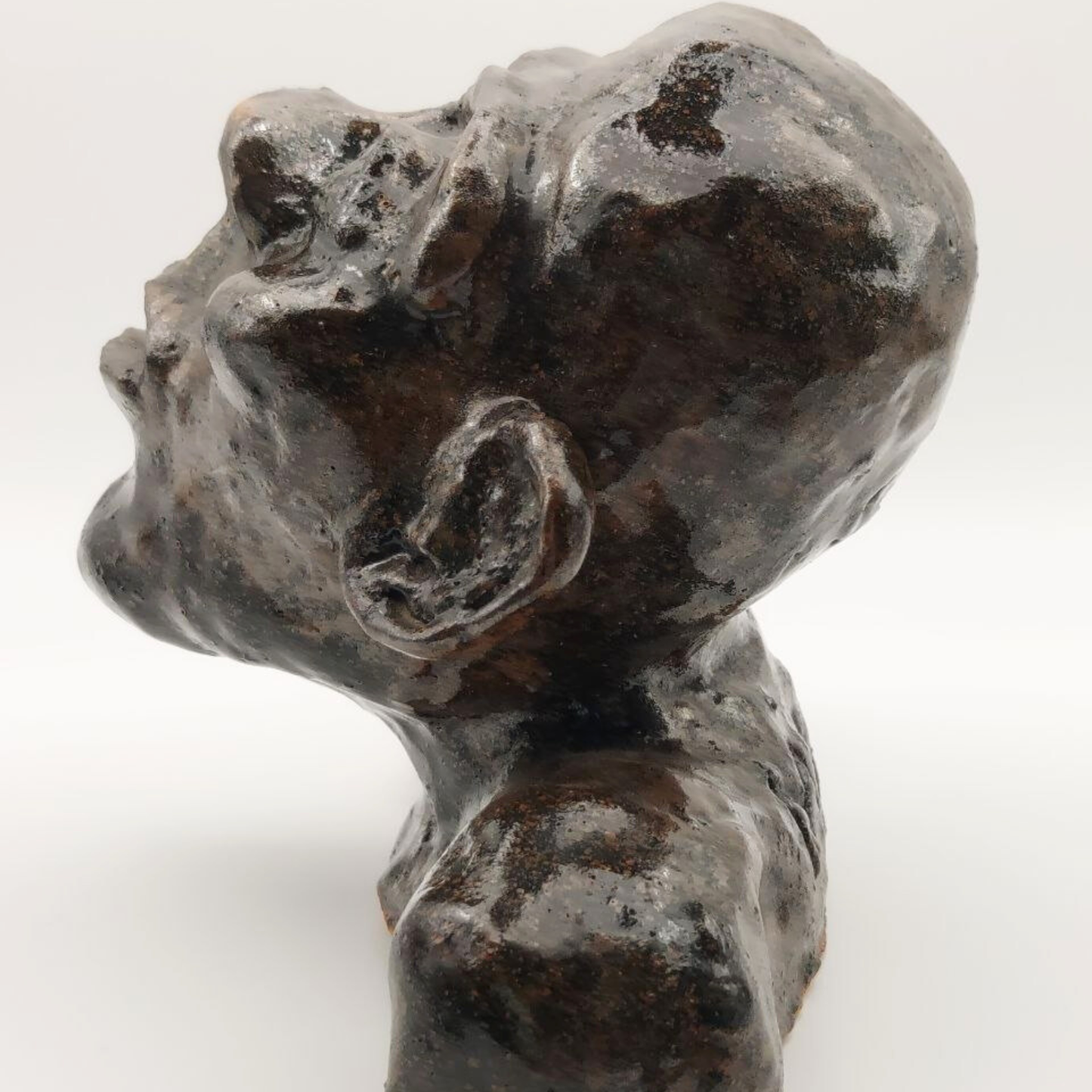 Ceramic bust against a white background - side-on view