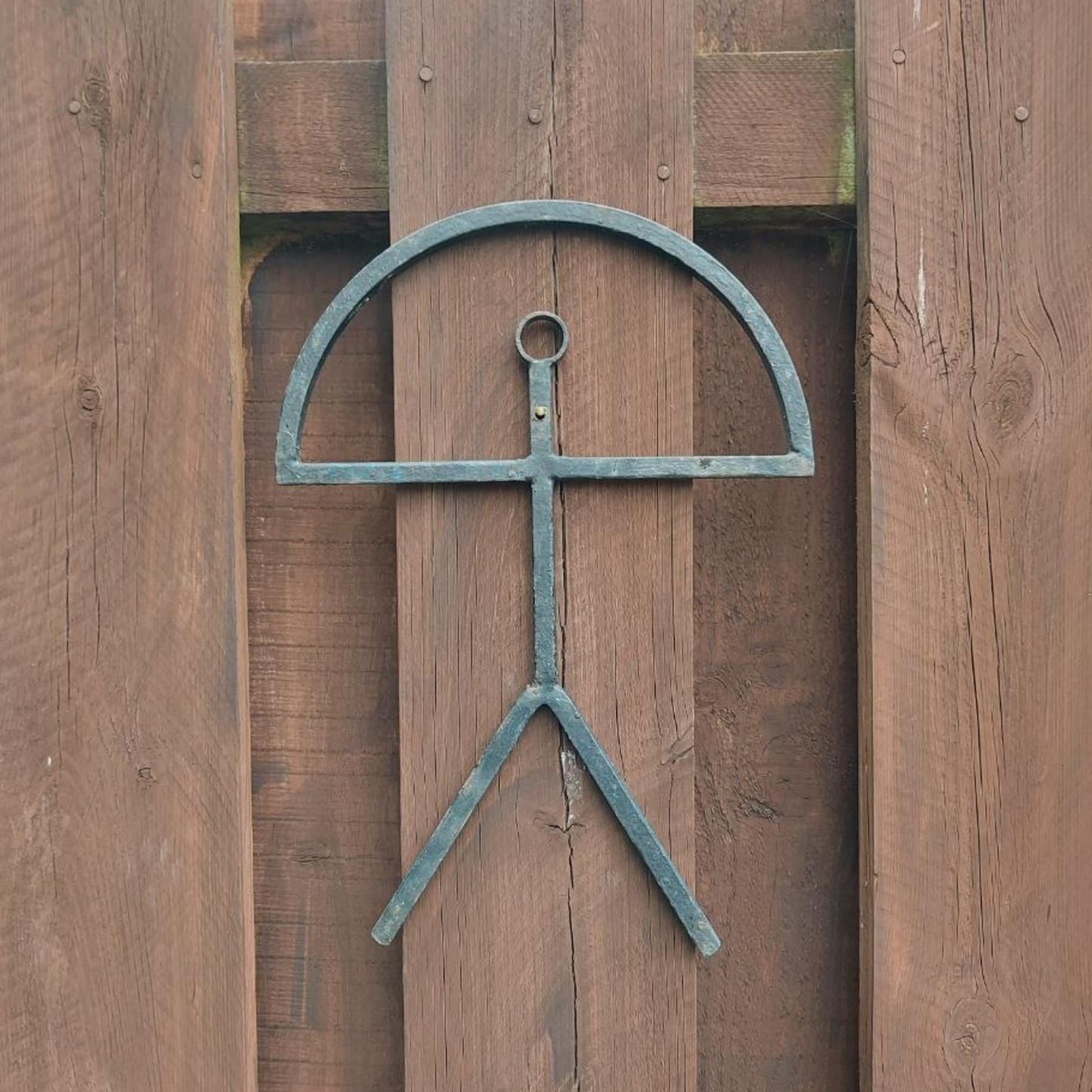 Decorative metal sculpture on a wooden background