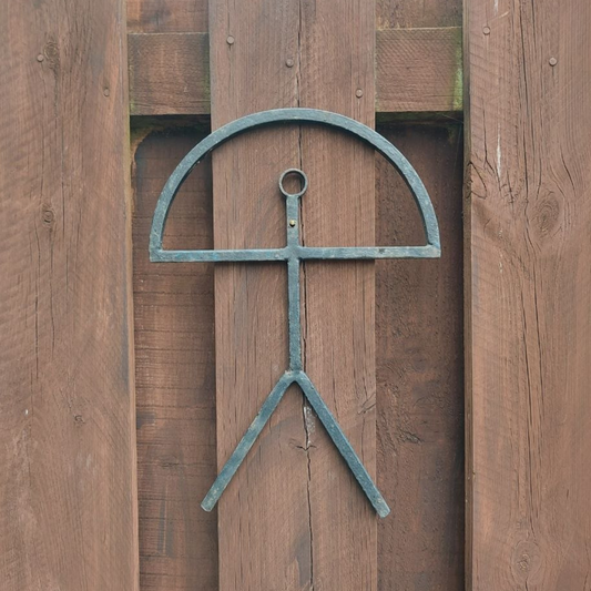 Decorative metal sculpture on a wooden background