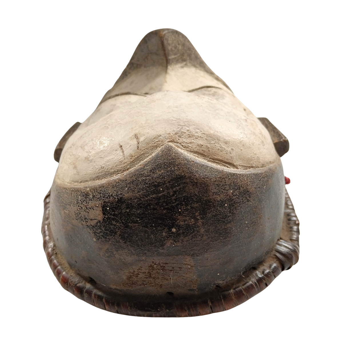 A carved wooden mask or decorative sculpture with a pointed top and weathered, rustic finish, shown against a plain white background.