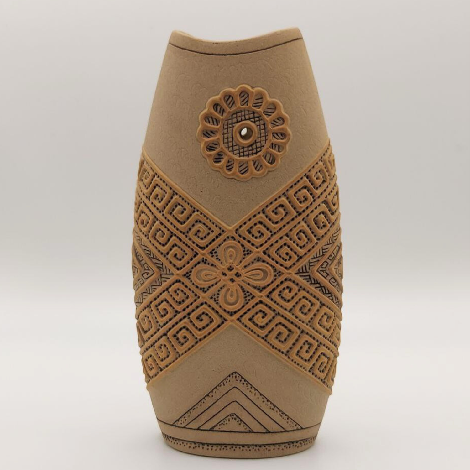 Decorative vase with geometric patterns on a white background