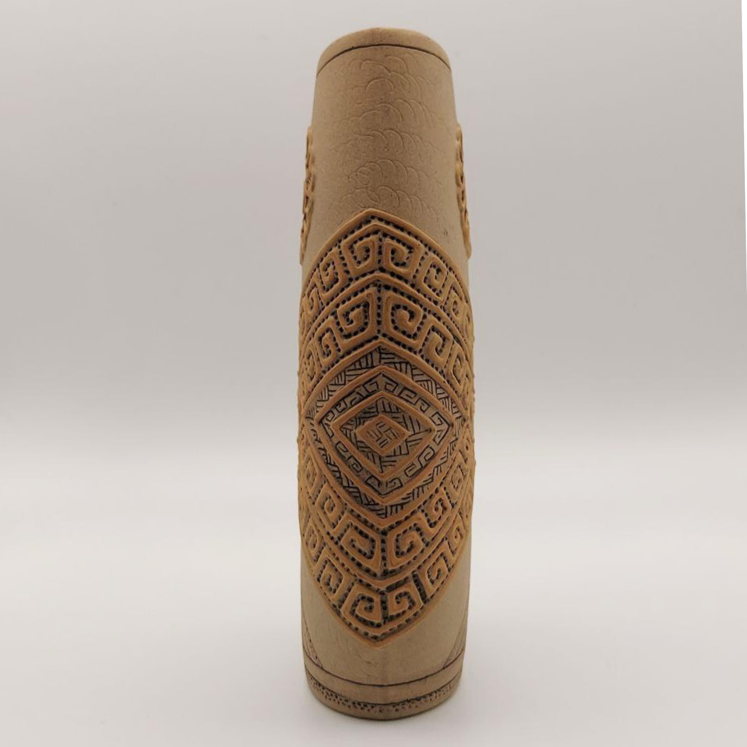 Brown clay vase with geometric patterns on a white background