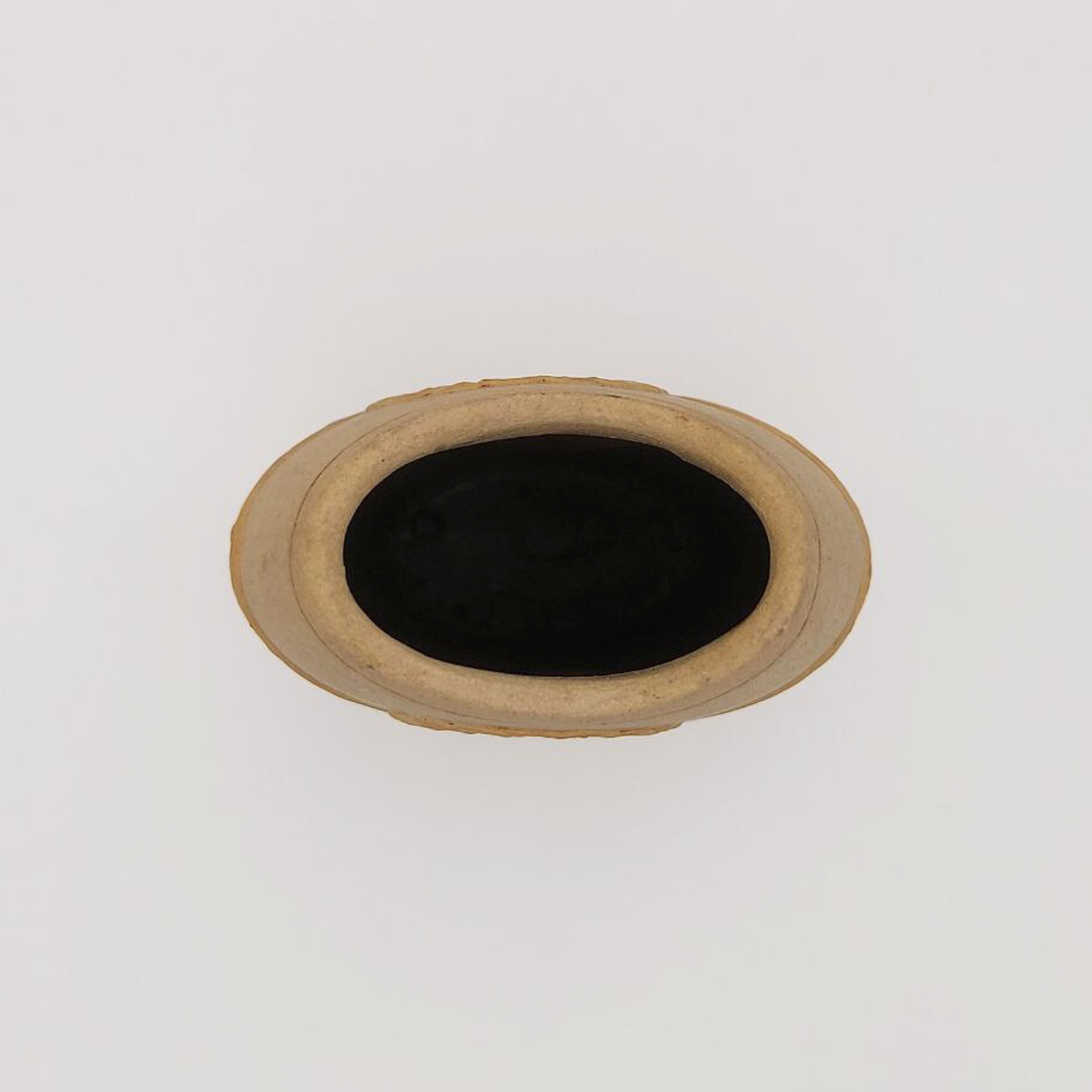 Top view of a small clay vase on a white background