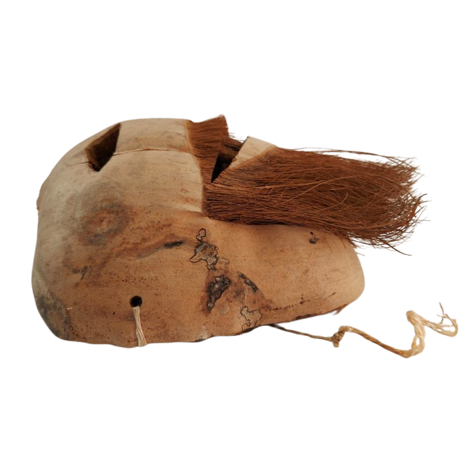 Vintage coconut husk mask from Ceylon on a white background