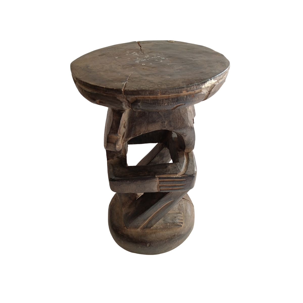 A rustic carved wooden stool with a round seat and a sculpted base, shown against a plain white background.