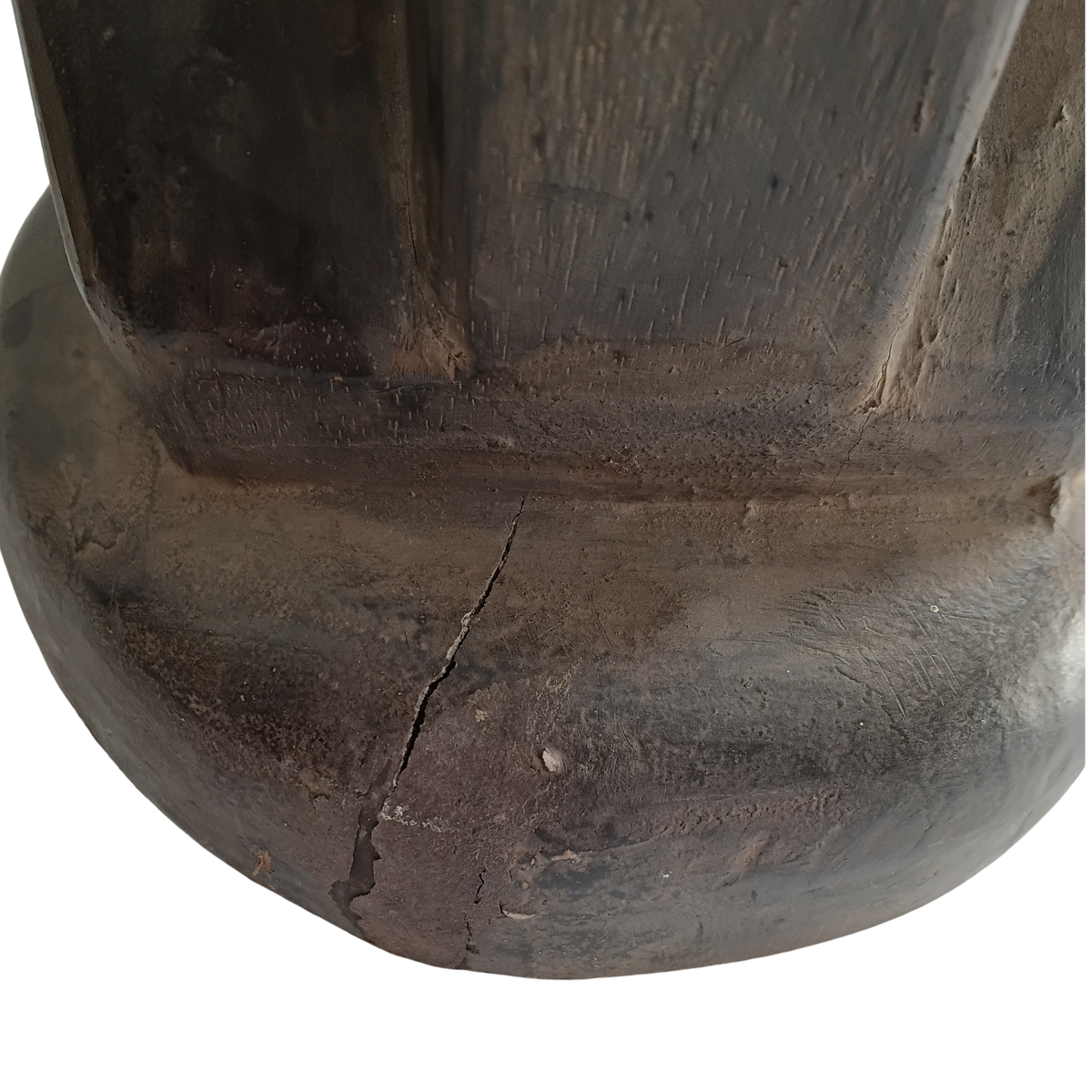 Close-up of a dark brown wooden stool with a visible crack on the front, set against a plain white background.