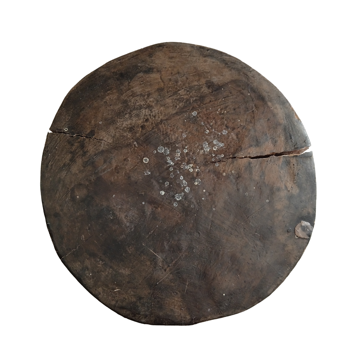 A round, dark brown wooden stool seat with visible grain, scratches, and a crack across the top, isolated on a white background.