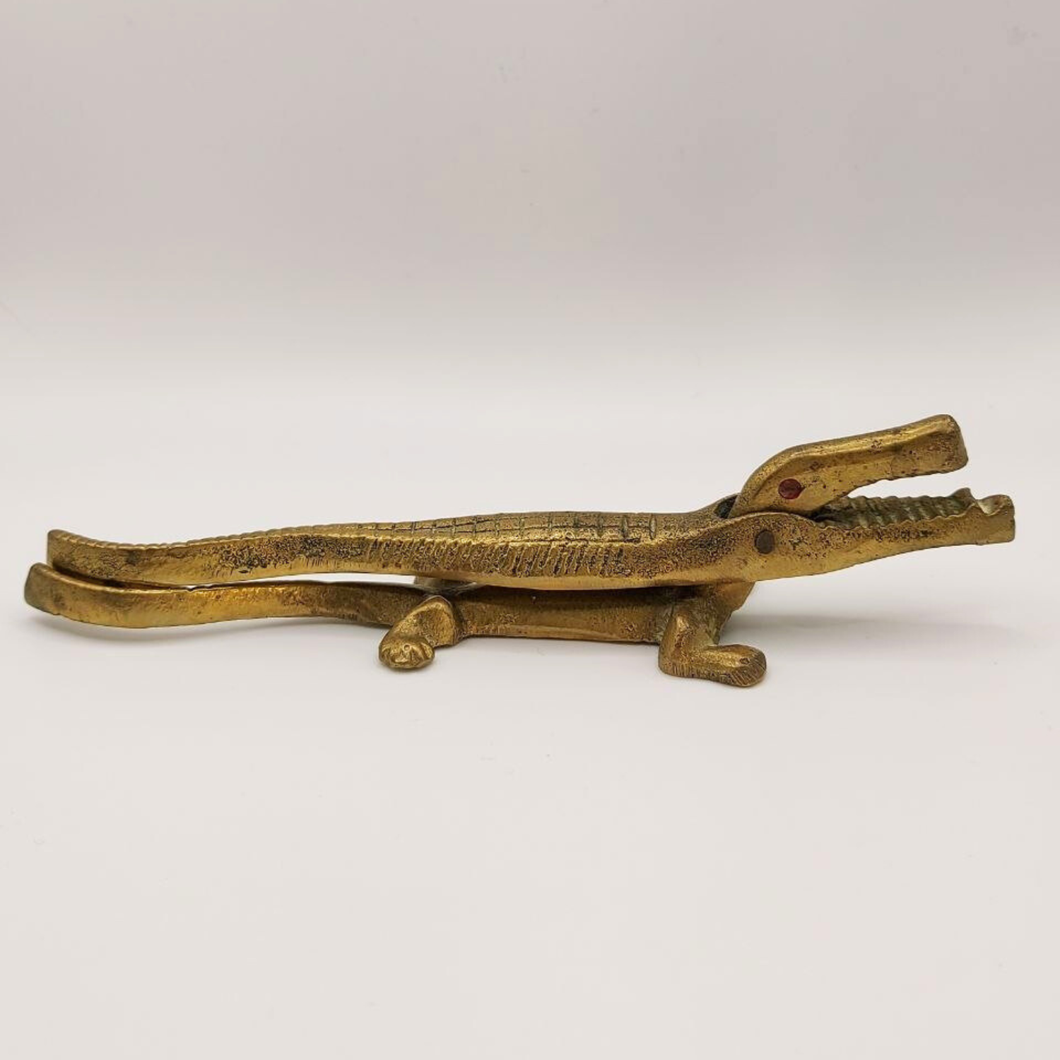 Bronze crocodile nutcracker on a white background