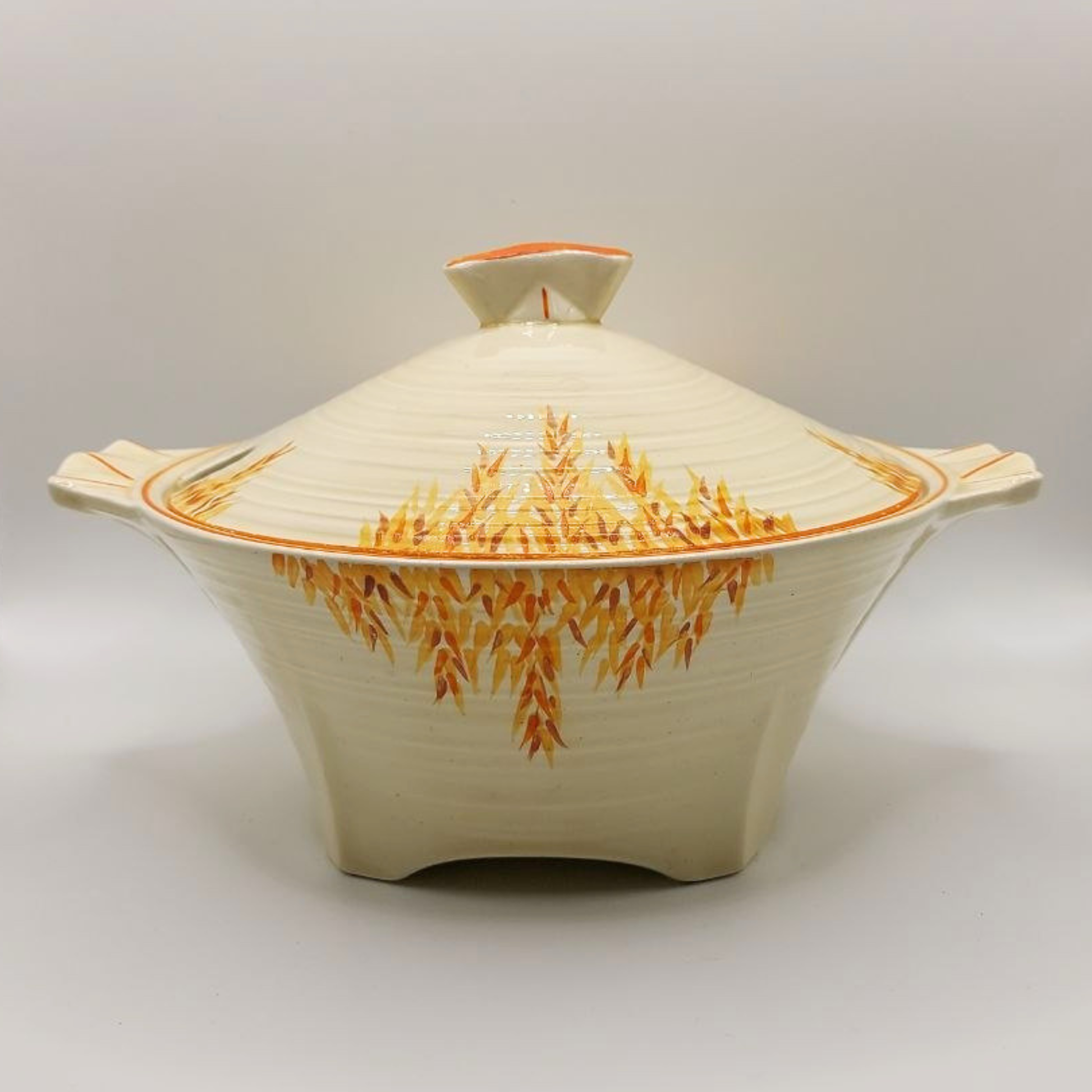 Ceramic tureen dish with lid featuring a floral pattern on a white background