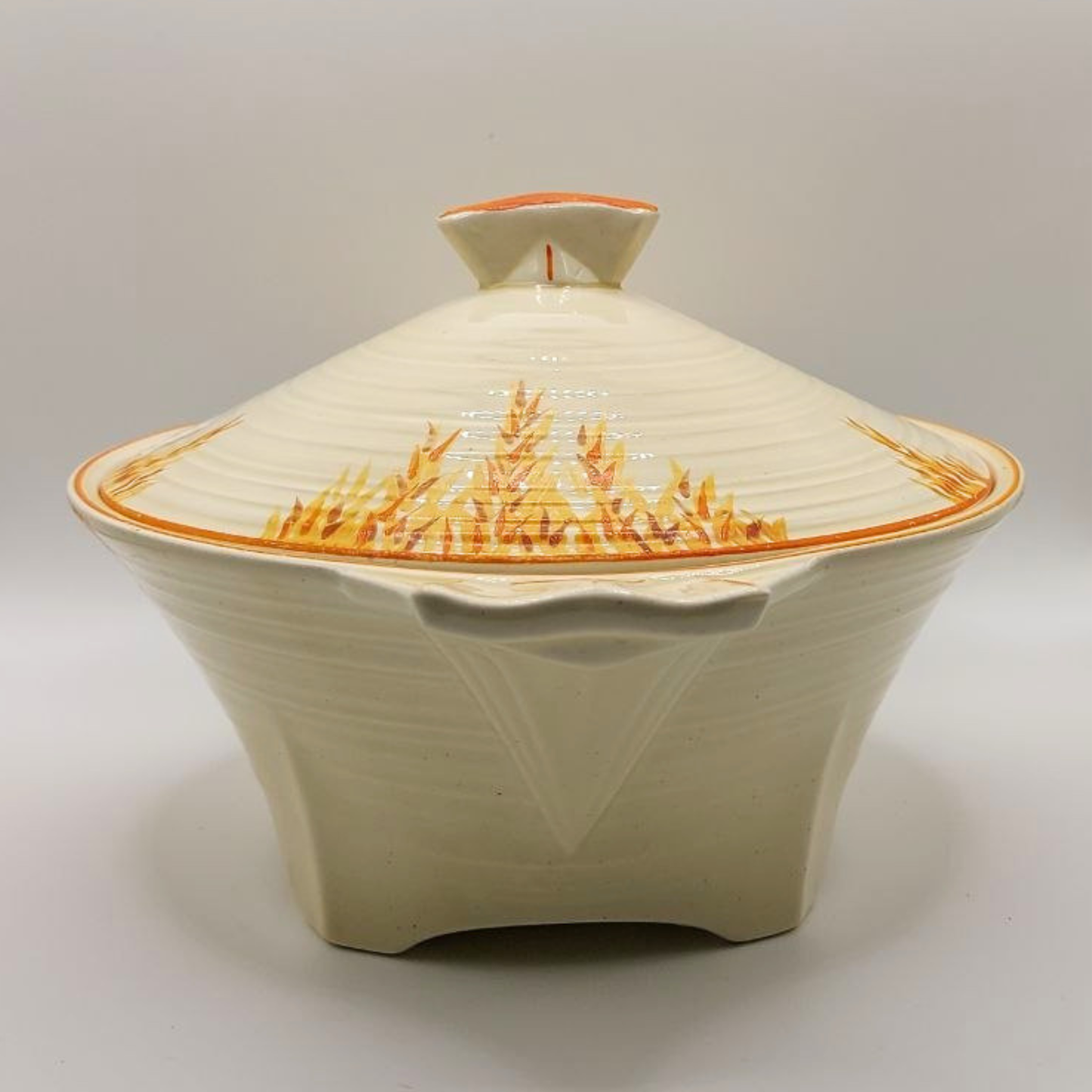 Ceramic dish with lid featuring a textured design on a plain background