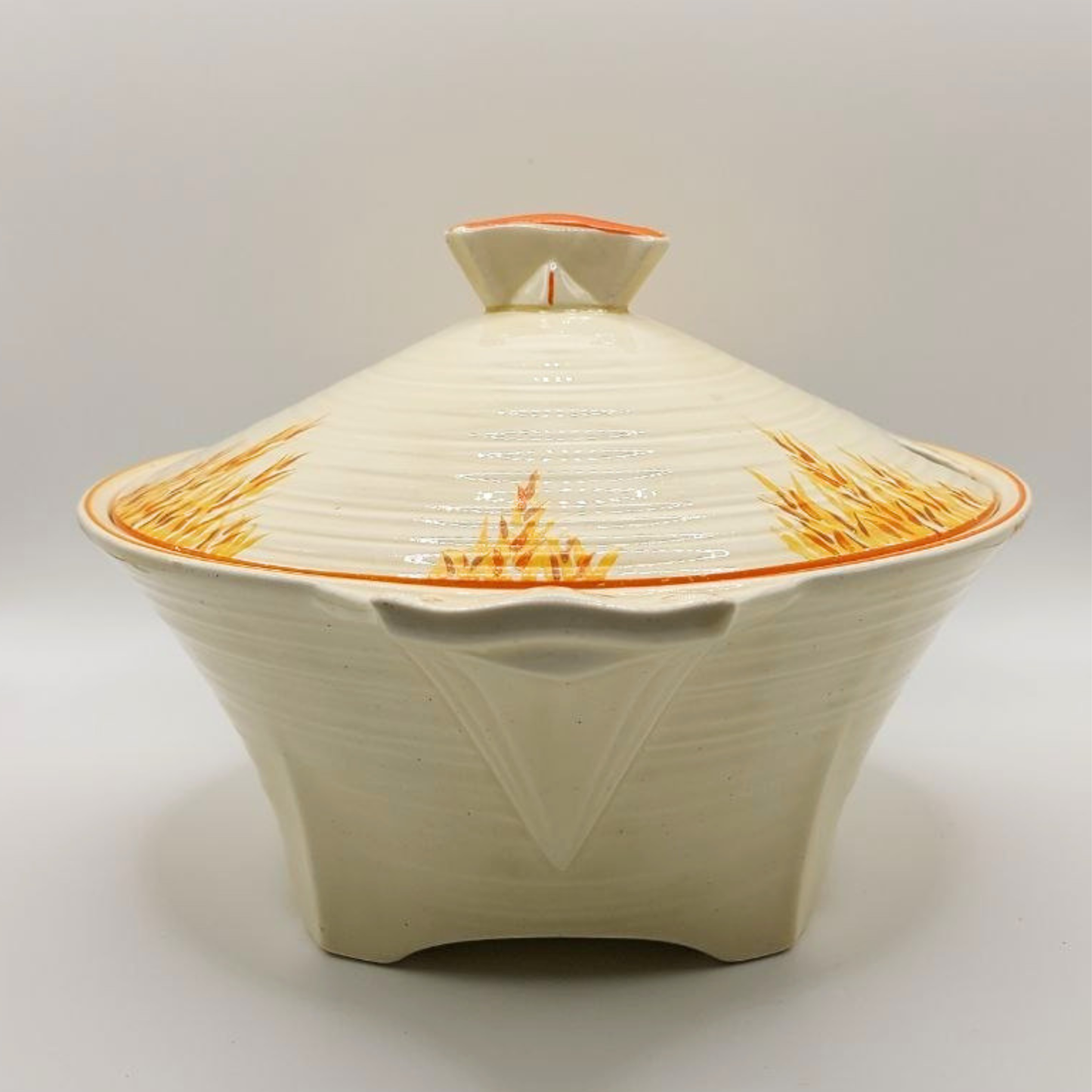 Ceramic dish with lid featuring a textured design on a light gray background