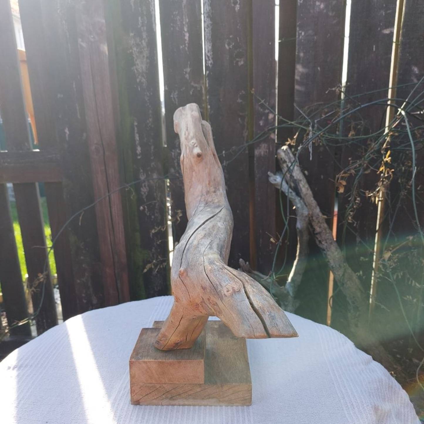 A driftwood sculpture on a garden table. 