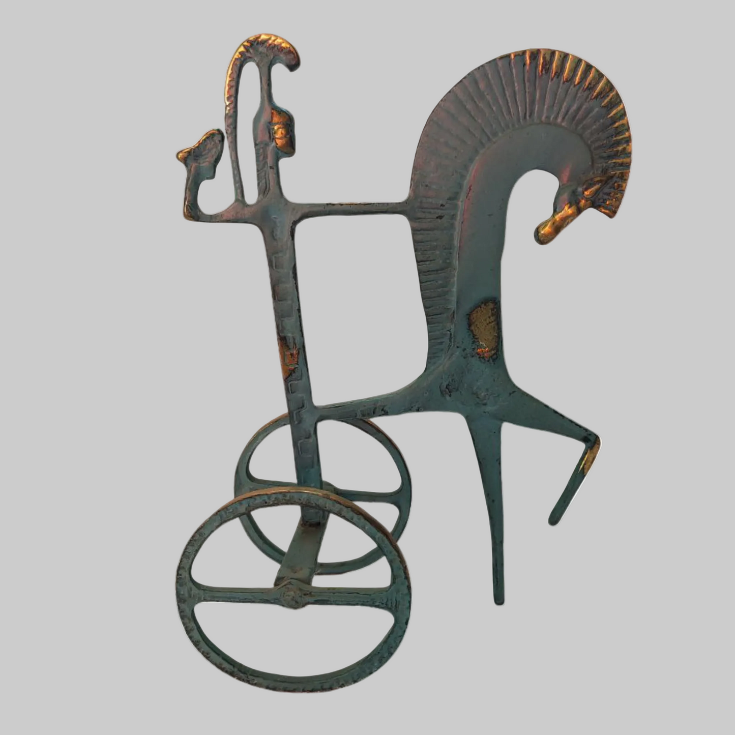 Decorative metal sculpture of a horse and rider on a white background
