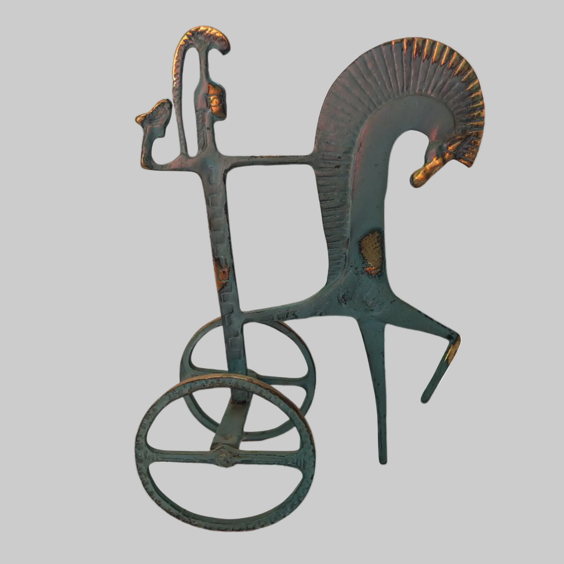 Decorative metal sculpture of a horse and rider on a white background