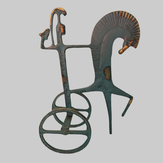 Decorative metal sculpture of a horse and rider on a white background