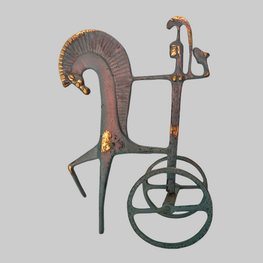 Decorative metal sculpture of a horse on a white background