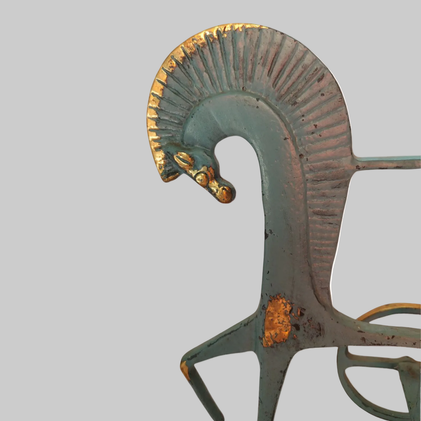 Decorative metal horse head sculpture with a white background