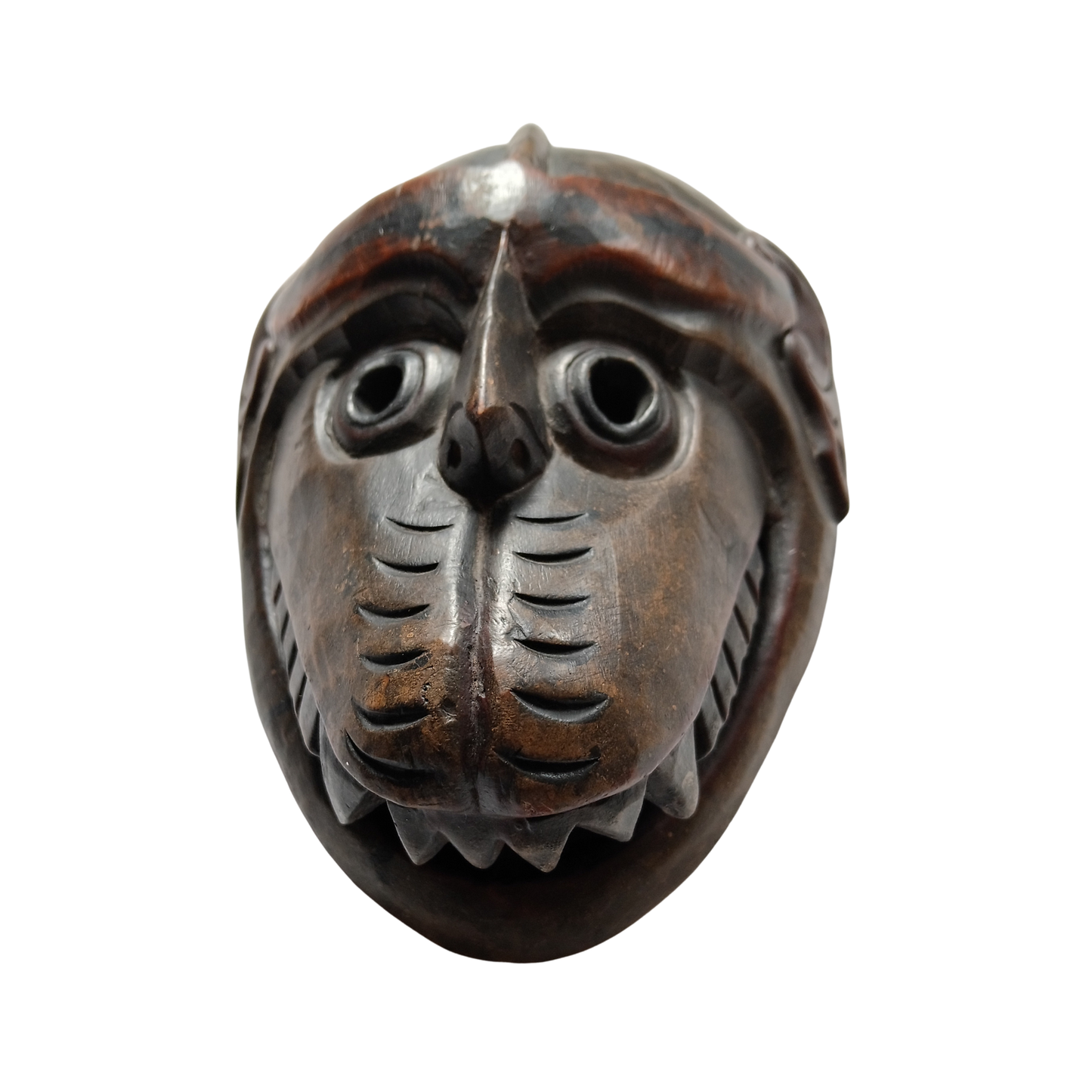A carved wooden mask with a stylised animal face, featuring prominent carved eyes, a beak, and textured facial details, shown against a plain white background.