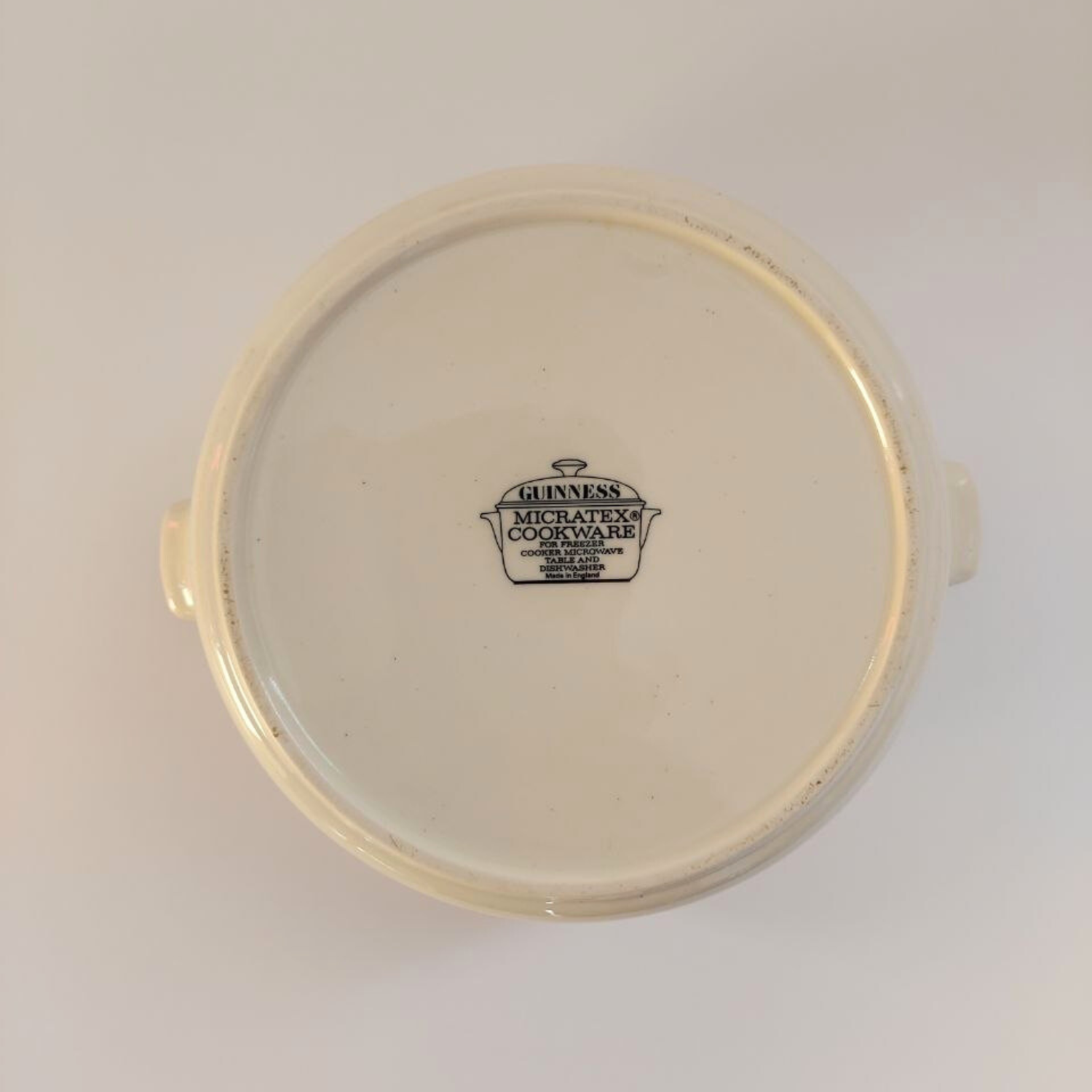 Round ceramic cookware base with Micratex Cookware logo on a white background