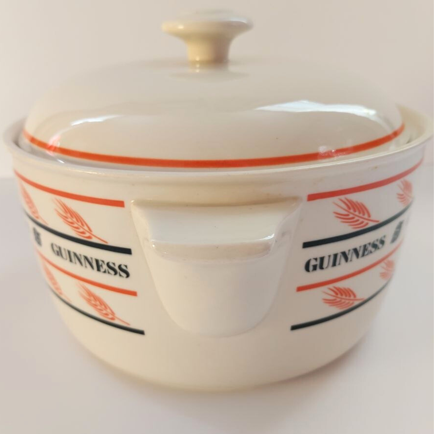 Ceramic dish with lid featuring Guinness branding on a white background