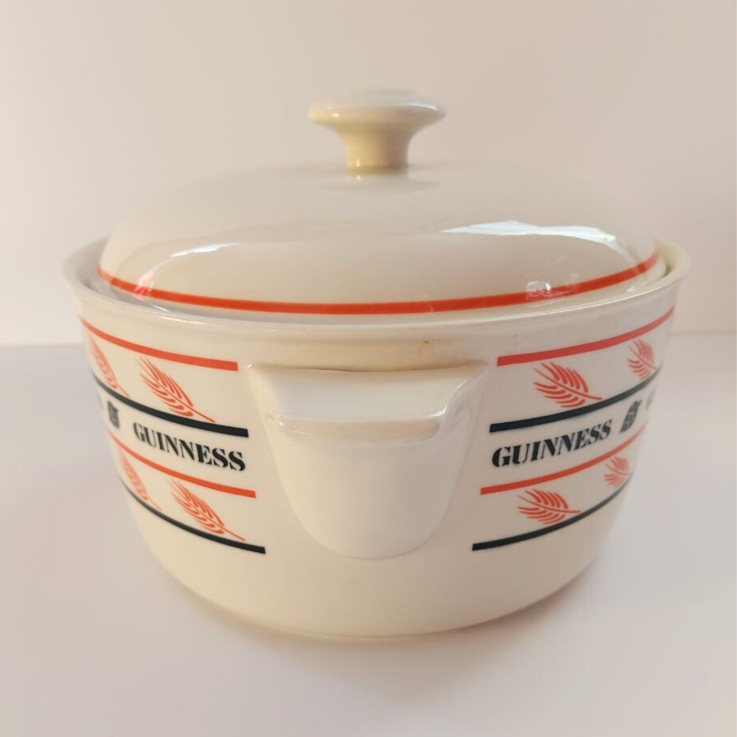White ceramic casserole dish with Guinness logo on a white background