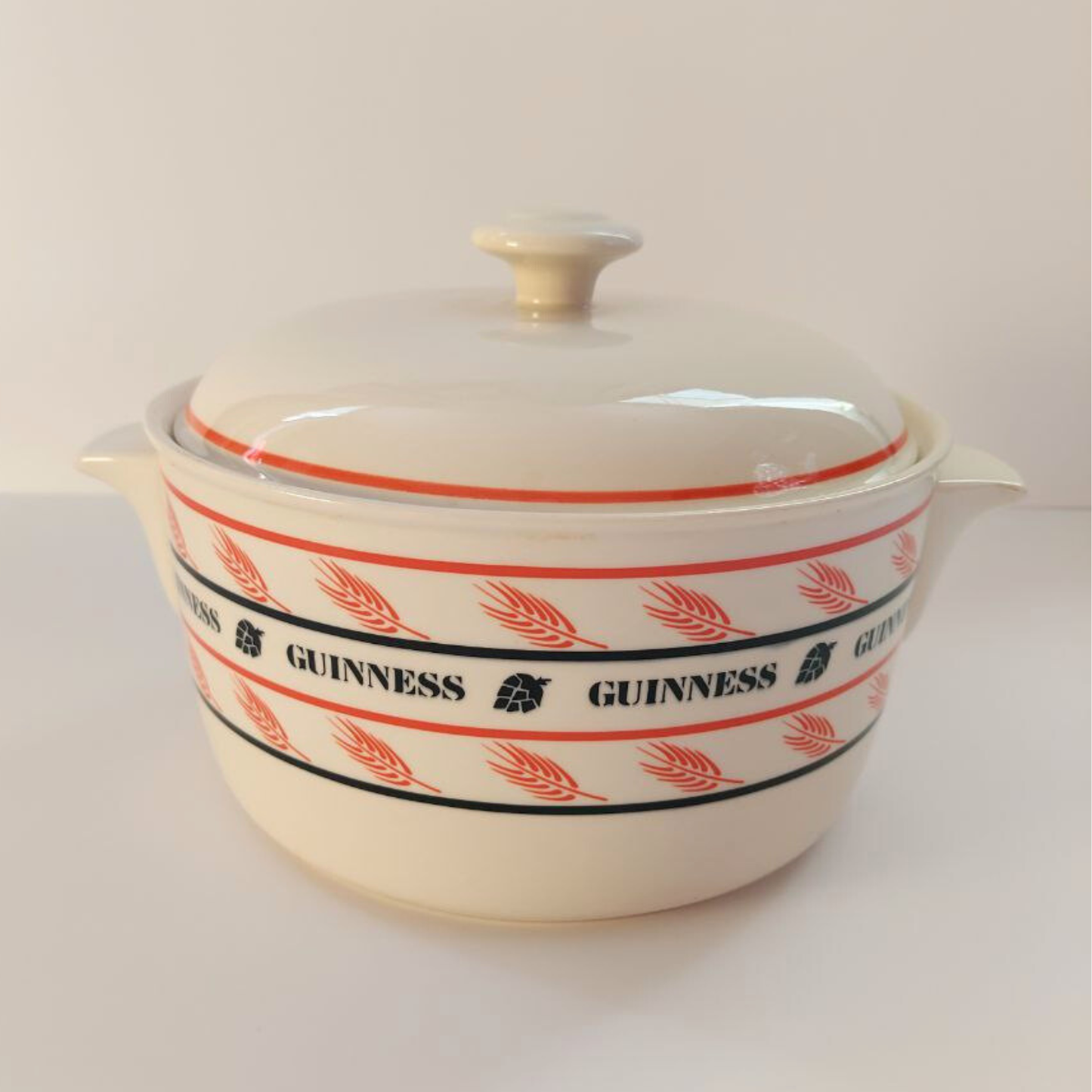 White ceramic dish with red and black Guinness logo on a white background