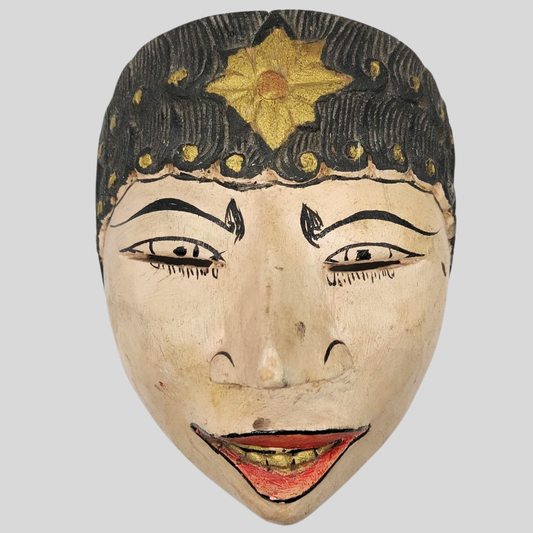 Traditional mask with decorative elements on a plain background