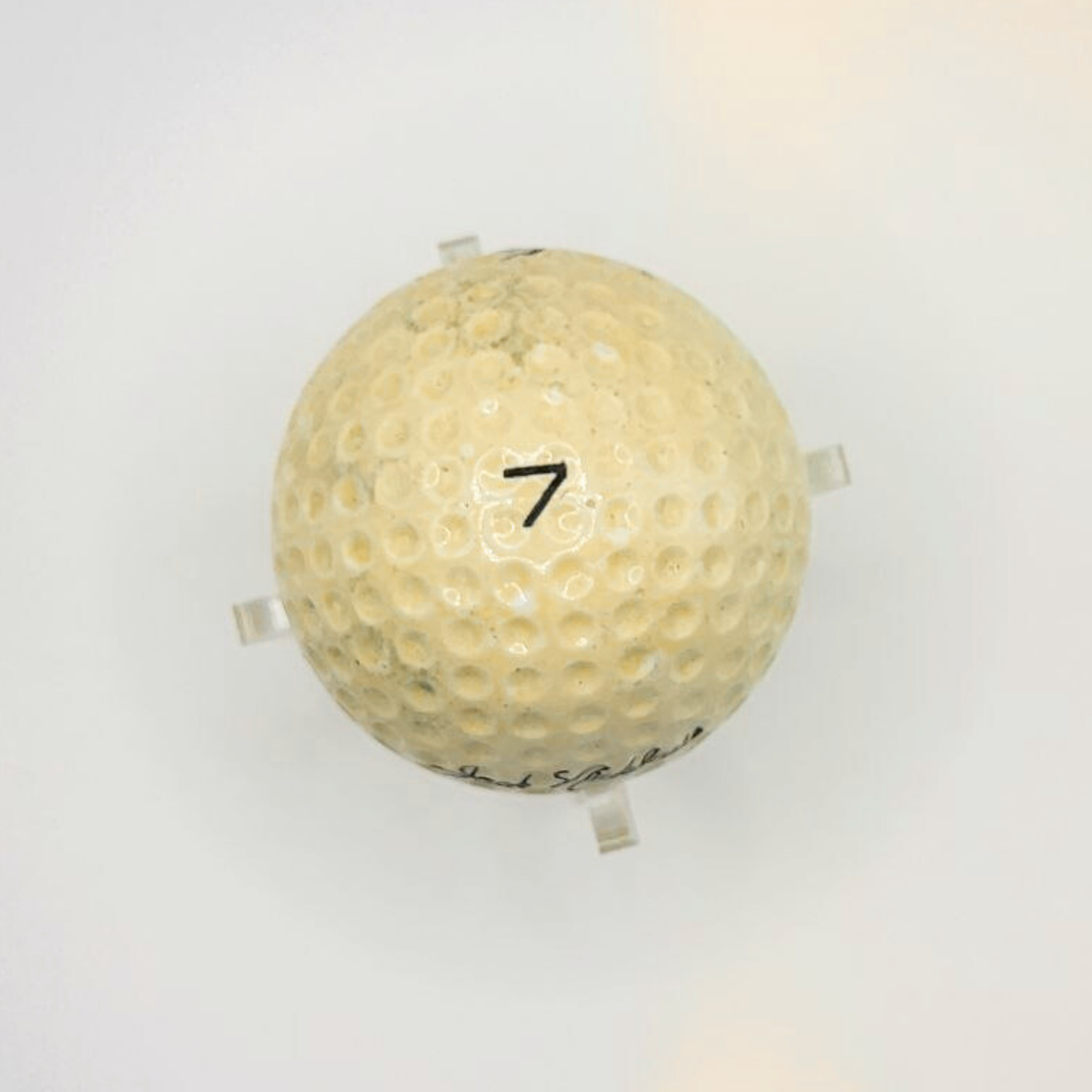 The top of a golf ball with the number 7 in the middle of it. 