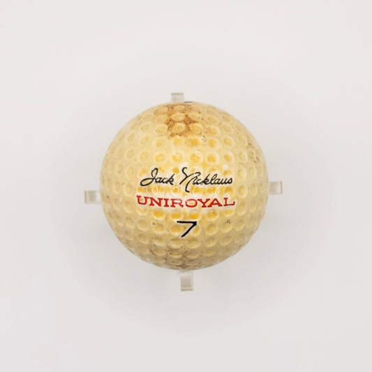 A vintage Jack Nicklaus Uniroyal golf ball against a white background. 