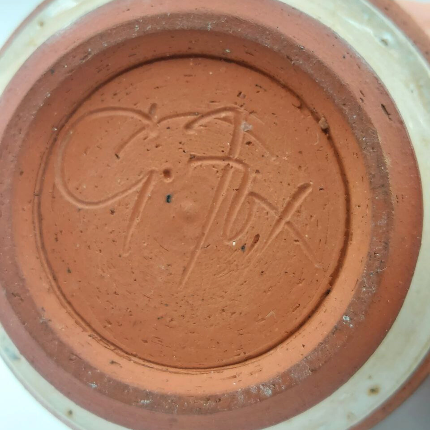 Close-up of a vase base with "G.Fox" on the bottom