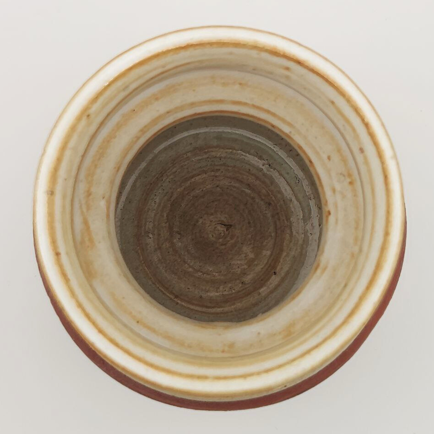 Close-up of a ceramic vase with a textured surface on a light gray background